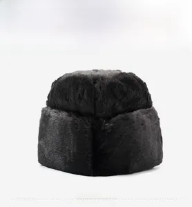 Close-up of thick black faux fur texture on a warm winter hat for men outdoors