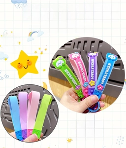 Detail of colorful PVC wrist straps with LovelyBear text and cute 3D charms