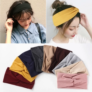 Elastic ribbed cotton yoga headbands for women in multiple colors worn by a model