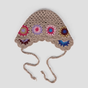 Detailed view of handmade crochet floral loli hat with vintage boho knit patterns