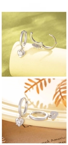 Gros plan détaillé de boucles d'oreilles en zircon en forme de cœur plaquées argent S925