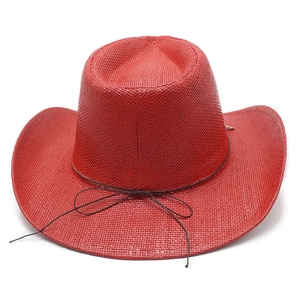 Detail of red wide-brim cowboy straw hat with fine weave texture and decorative thin rope