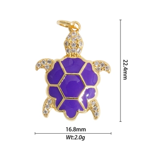 Detailed view of 18K gold turtle pendant with purple enamel and zircon inlay