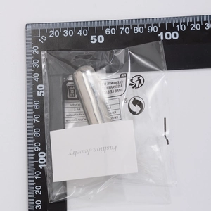 Macro view of silver capsule hair accessory on a measuring scale for precise sizing