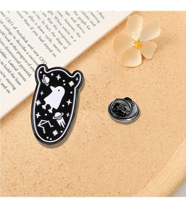 Detailed view of creative black enamel alien ghost brooch with celestial star patterns