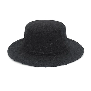 Detailed macro view showing the thick faux wool texture of the black flat top pork pie hat