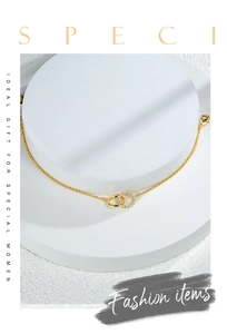 Detail of gold-plated double interlocking rings bracelet with sparkling cubic zirconia inlay