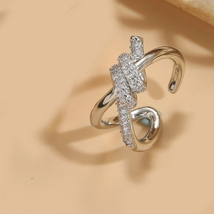 Macro shot of a silver knotted open ring with shimmering clear cubic zirconia stones