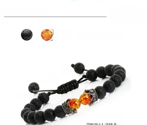 Detail of adjustable lava stone and amber bead bracelet with metal crown accent