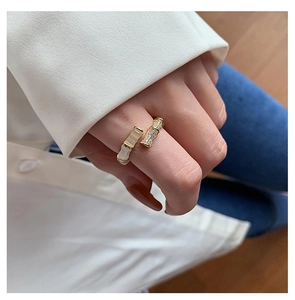 Detailed shot of bamboo style open ring with rectangular gemstone and pavé zircon stones