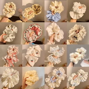 Collage of diverse floral, plaid and lace fabric hair scrunchies in 16 assorted styles