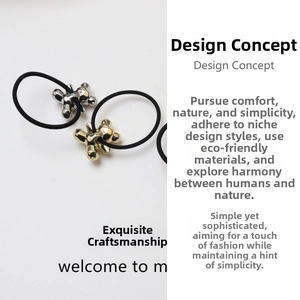 Detail view of liquid metal style gold and silver bear charms on black elastic hair ties