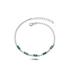Detail view of silver bracelet showing 6.5mm rectangular emerald stones and metal chain