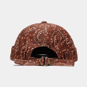 Détail du bonnet docker marron à motif paisley avec texture velours et boucle métallique
