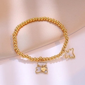 Golden beaded titanium bracelet featuring hollow bear pendants and engraved heart charm