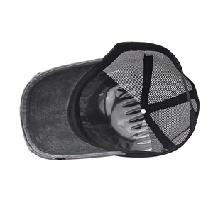 Detail view of cotton blend trucker hat interior with mesh panel and fabric tag