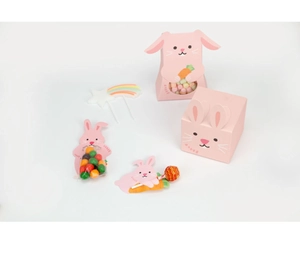 Detail showing pink rabbit paper gift boxes for candy and lollipops on white background