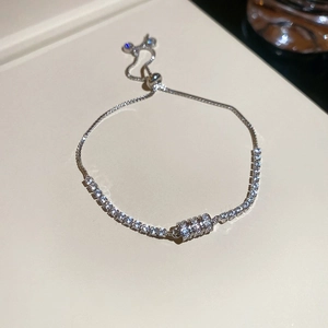 Close-up of zircon flower tennis bracelet featuring an adjustable slider clasp detail