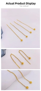 Detail of 18K gold-plated long tassel earrings with matte and polished steel beads