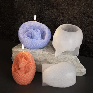 3D dragon egg silicone mold with finished candles showing detailed dragon scale textures