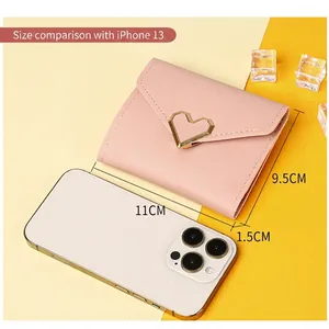 Pink heart buckle short tri-fold wallet for women, size comparison with iPhone