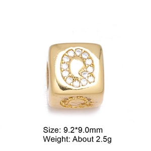 Detailed macro of 8mm gold-plated letter Q bead with micro-pave white zircon stones