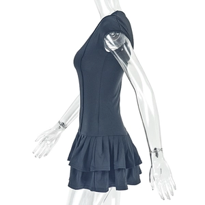 Detail shot of black bodycon dress featuring double-layered ruffled hem and slim-fit tailoring