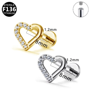 Detailed macro view of heart-shaped F136 titanium body jewelry with zircon and internal threads