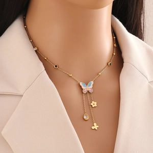 Golden butterfly and flower charm necklace with colorful enamel and sparkling crystals