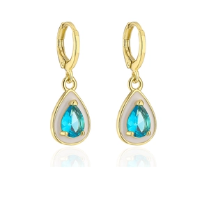 Detail of bohemian gold drop earrings with blue zircon stones and white enamel accents