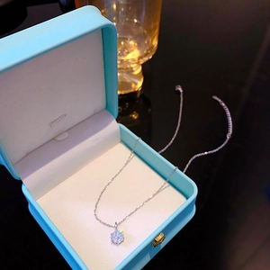 Elegant silver necklace with six-prong set zircon pendant in a light blue jewelry box