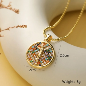 Macro shot of gold plated cross pendant necklace with colorful cubic zirconia stones
