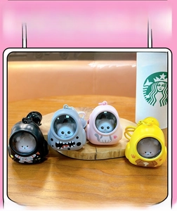 Detailed view of cat space capsule keychains in four colors with cute feline figures