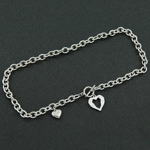 Silver stainless steel toggle chain necklace featuring solid and hollow heart pendants