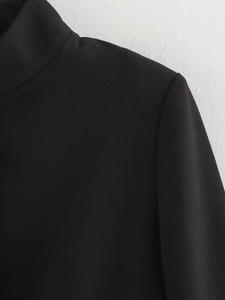 Detail shot of the ribbed texture and high collar stitching on this black jacket
