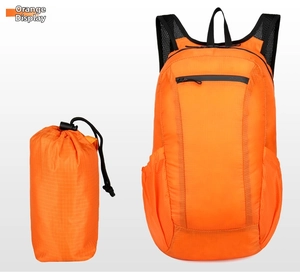 Orange foldable lightweight backpack shown beside its compact cylindrical storage bag