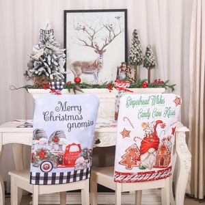 Christmas gnome chair covers with red truck and gingerbread house patterns for festive dining