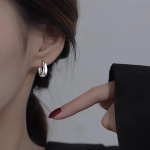Minimalist silver hoop earrings on model showing stylish daily wear look