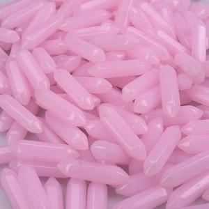 Close-up of bulk pink hexagonal double-pointed crystal pillars for DIY jewelry