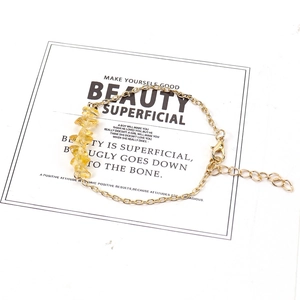 Detail view of natural yellow crystal stone bracelet with adjustable gold alloy chain