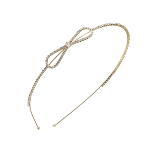 Elegant gold metal headband with rhinestone bowknot ornament on a white background