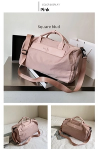 Pink waterproof travel bag detail with reinforced handles and adjustable shoulder strap