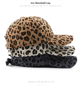 Close-up of corduroy baseball caps in brown, cream, and dark grey leopard print patterns