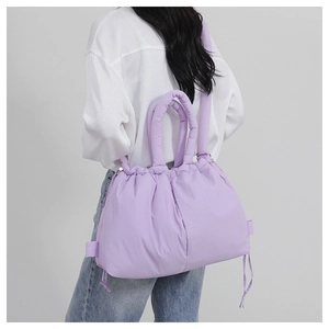 Quilted lavender tote bag with drawstring closure shown on model for size and volume