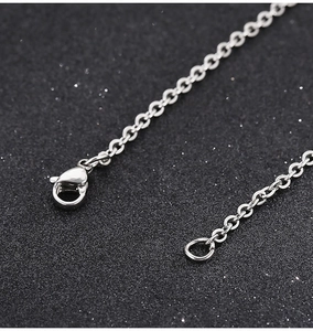 Detailed macro view of silver stainless steel chain with lobster clasp and jump ring