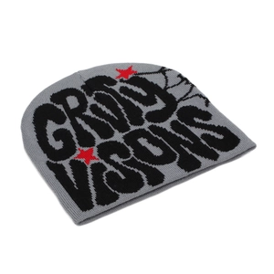 Detail of the thick ribbed knit texture and black jacquard letters on the grey beanie