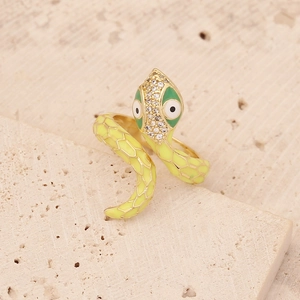 Detailed close-up of a golden snake ring with yellow enamel and sparkling rhinestones