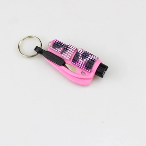Close-up of pink glitter car escape tool showing the integrated metal seatbelt cutter