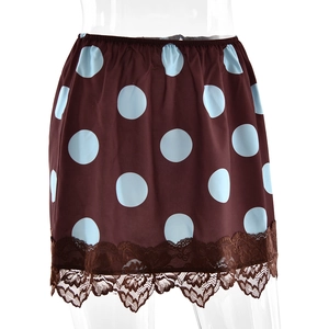 Close-up of brown satin skirt with light blue polka dots and brown lace hem detail