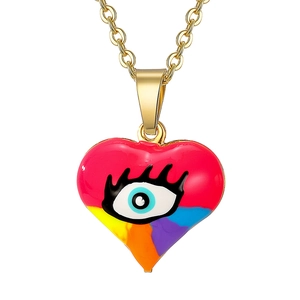 Close-up of heart-shaped evil eye pendant with vibrant multicolor enamel and gold plating